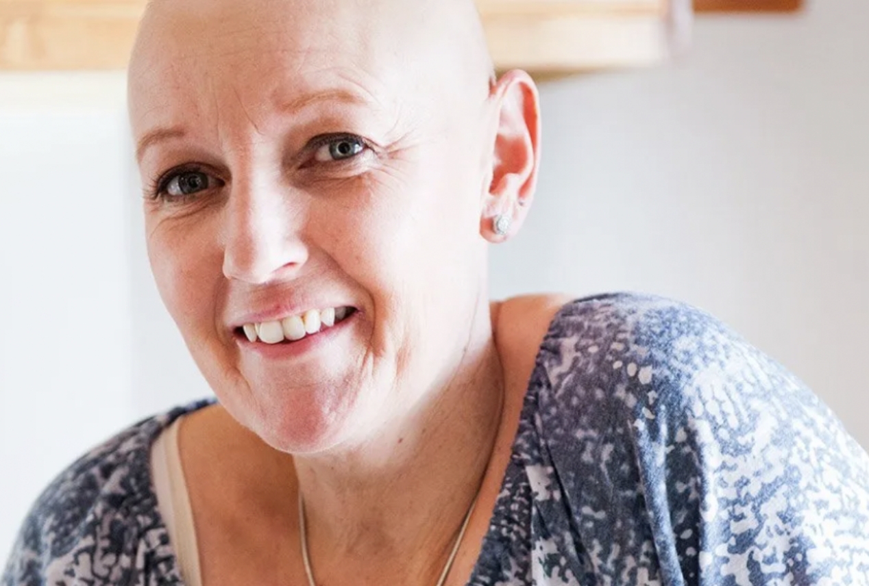 A woman cancer patient in the hospital smiling