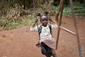 A young girl swinging on a swing