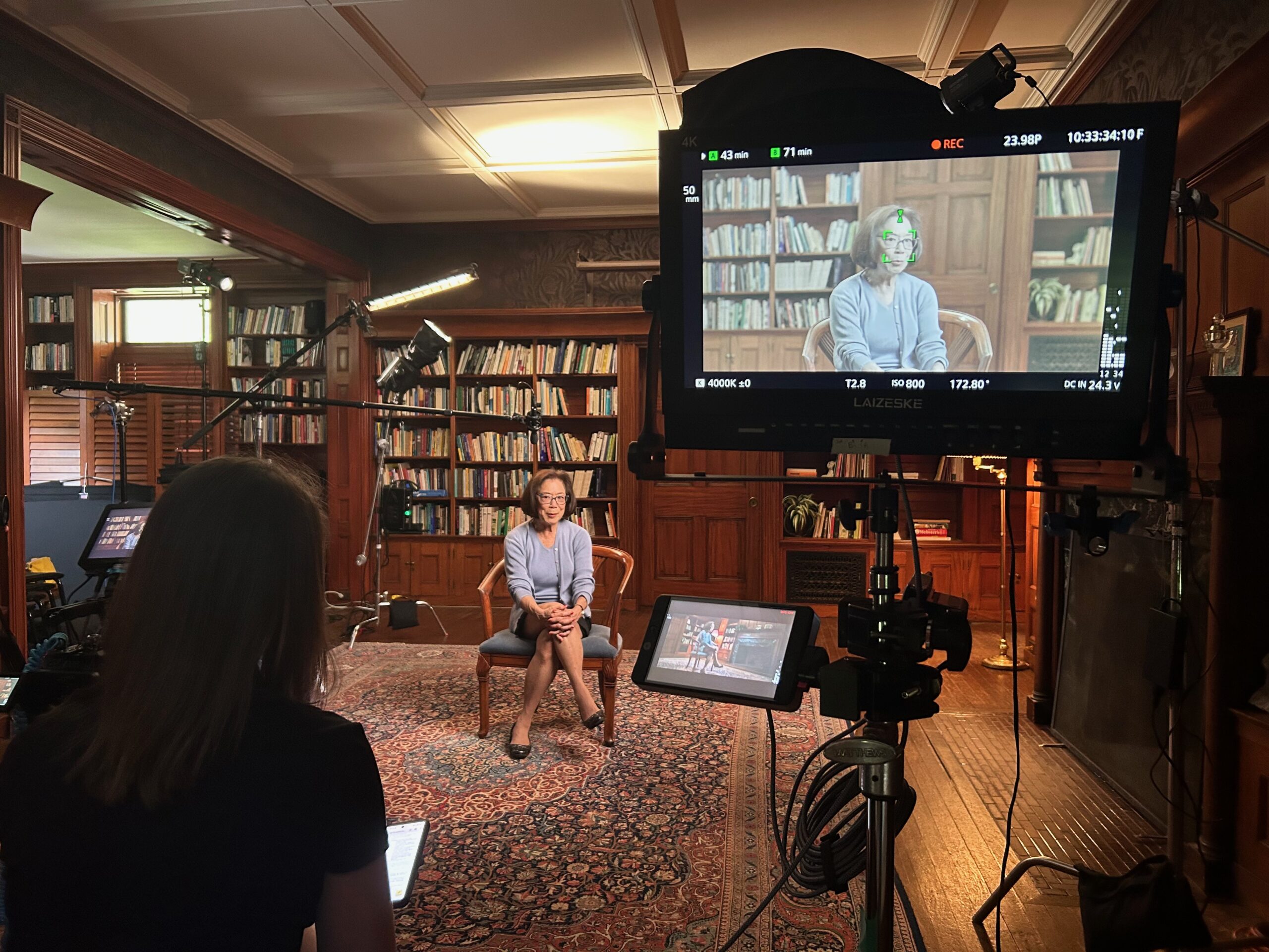 Elaine Woo sitting in a chair being interviewed on camera